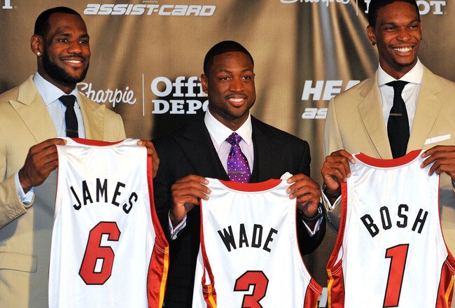 MIAMI - JULY 09:  LeBron James #6, Dwyane Wade #3 and Chris Bosh #1 of the Miami Heat show off their new game jerseys before a press conference after a welcome party at American Airlines Arena on July 9, 2010 in Miami, Florida.  (Photo by Doug Benc/Getty Images)