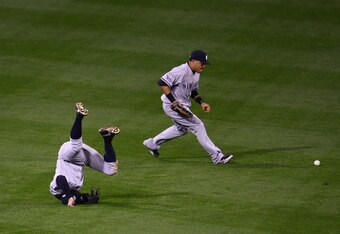 PHILADELPHIA - NOVEMBER 01:  Johnny Damon #18 of the New  York Yankees falls down after he couldn't make a play on a RBI double  hit by Chase Utley #26 of the Philadelphia Phillies in the bottom of the  first inning of Game Four of the 2009 MLB World Series at Citizens Bank  Park on November 1, 2009 in Philadelphia, Pennsylvania.  (Photo by  Chris McGrath/Getty Images)