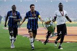 MADRID, SPAIN - MAY 22: (L-R) Sulley Muntari, Javier Zanetti and Mario Balotelli of Inter Milan celebrate with the UEFA Champions League trophy following their victory at the end of the UEFA Champions League Final match between FC Bayern Muenchen and Inter Milan at the Estadio Santiago Bernabeu on May 22, 2010 in Madrid, Spain.  (Photo by Jasper Juinen/Getty Images)