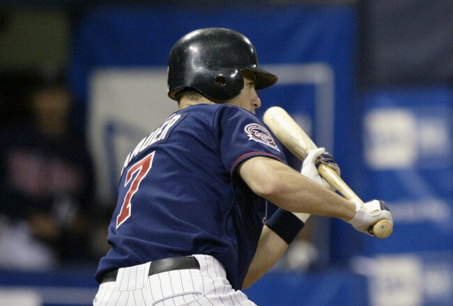 MINNEAPOLIS - AUGUST 6:  Catcher Joe Mauer #7 of the Minnesota Twins bunts against the Boston Red Sox during the game on August 6, 2005 at the Hubert H. Humphrey Metrodome in Minneapolis, Minnesota.  The Twins won 4-3.  (Photo by David Sherman/Getty Images)