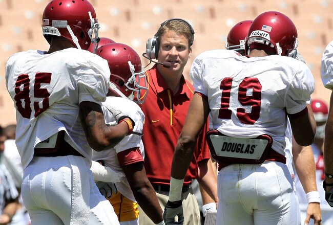 LOS ANGELES, CA - MAY 01:  Head coach Lane Kiffin gives instructions in the offensive huddle during the  USC Trojans spring game on  May 1, 2010 at the Los Angeles Memorial Coliseum in Los Angeles, California.  (Photo by Stephen Dunn/Getty Images)