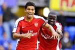 LIVERPOOL, ENGLAND - AUGUST 15:   Da Silva Eduardo of Arsenal celebrates with teammate Emmanuel Eboue (R) after scoring his team's sixth goal during the Barclays Premier League match between Everton and Arsenal at Goodison Park on August 15, 2009 in Liverpool, England. (Photo by Michael Regan/Getty Images)