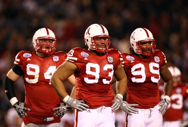 SAN DIEGO, CA - DECEMBER 30:  Defensive Tackle Ndamukong Suh #93 of the University of Nebraska Cornhuskers looks on with teammates Jared Crick #94 and Barry Turner #99 against the University of Arizona Wildcats during the Pacific Life Holiday Bowl,  on December 30, 2009 at Qualcomm Stadium in San Diego, California. (Photo By Donald Miralle/Getty Images)