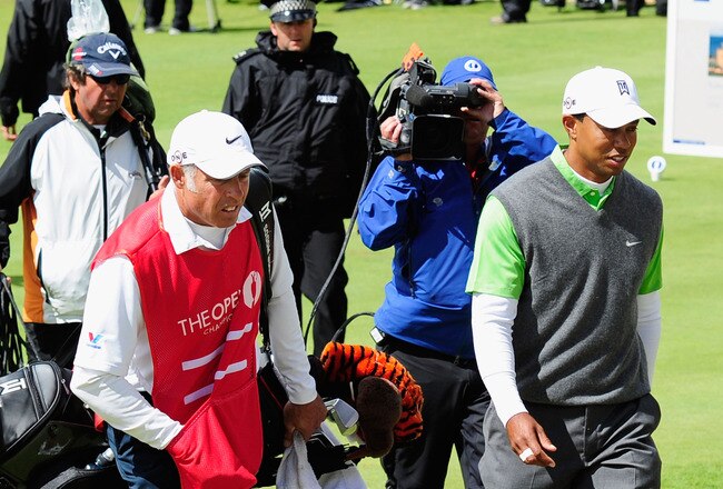 ST ANDREWS, SCOTLAND - JULY 16:  Tiger Woods of the USA walks off the first hole alongside his caddie Steve Williams after play was suspended by high winds during the second round of the 139th Open Championship on the Old Course, St Andrews on July 16, 2010 in St Andrews, Scotland.  (Photo by Stuart Franklin/Getty Images)