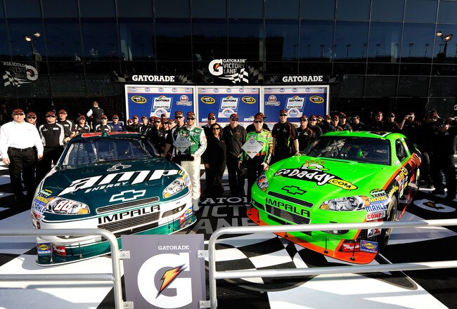 DAYTONA BEACH, FL - FEBRUARY 06:  Dale Earnhardt Jr., driver of the #88 AMP Energy Chevrolet, and Mark Martin, driver of the #5 GoDaddy.com Chevrolet, poses after qualifying on the front row for the Daytona 500 at Daytona International Speedway on February 6, 2010 in Daytona Beach, Florida.  (Photo by John Harrelson/Getty Images for NASCAR)
