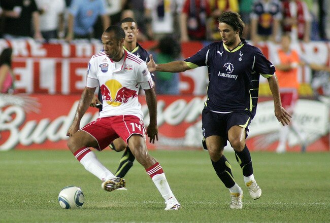 HARRISON, NJ - JULY 22: Theirry Henry #14 of the New York Red Bulls plays the ball while being defended by Niko Kranjcar #21 of Tottenham Hotspur during their game at Red Bull Arena on July 22, 2010 in Harrison, New Jersey. Tottenham Hotspur defeated the Red Bulls 2-1. (Photo by Andy Marlin/Getty Images for the New York Red Bulls)