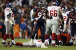 DENVER - NOVEMBER 26:  Elvis Dumervil #92 of the Denver Broncos reacts after forcing a fumble by quarterback Eli Manning #10 of the New York Giants leading to a Broncos recovery during NFL action at Invesco Field at Mile High on November 26, 2009 in Denver, Colorado. The Broncos defeated the Giants 26-6.  (Photo by Doug Pensinger/Getty Images)