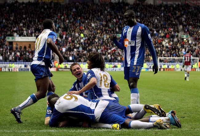 WIGAN, ENGLAND - MARCH 20:  Hugo Rodallega of Wigan is congratulated after after scoring the winning goal during the Barclays Premier League match between Wigan Athletic and Burnley at the JJB Stadium on March 20, 2010 in Wigan, England.  (Photo by Ross Kinnaird/Getty Images)