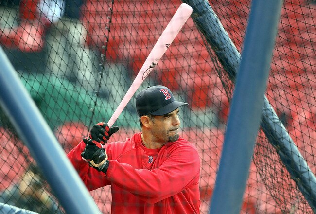 BOSTON - MAY 9:  Mike Lowell #25 of the Boston Red Sox takes batting practice with a pink bat, a symbol to raise breast cancer awareness, before a game against the New York Yankees at Fenway Park on May 9, 2010 in Boston, Massachusetts. On occasion of Mother's Day, the Boston Red Sox have partnered with Major League Baseball to raise breast cancer awareness as part of Major League Baseball's Going to Bat Against Breast Cancer initiative.  (Photo by Jim Rogash/Getty Images)