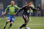 SEATTLE - JUNE 10:  Barry Rice #15 of D.C. United dribbles against Freddie Ljungberg #10 of the Seattle Sounders FC on June 10, 2010 at Qwest Field in Seattle, Washington. (Photo by Otto Greule Jr/Getty Images)