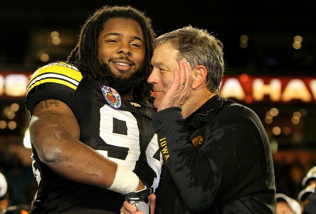 MIAMI GARDENS, FL - JANUARY 05:  (L-R) Adrian Clayborn #94 and head coach Kirk Ferentz of the Iowa Hawkeyes celebrate after their 24-14 win against the Georgia Tech Yellow Jackets during the FedEx Orange Bowl at Land Shark Stadium on January 5, 2010 in Miami Gardens, Florida.  (Photo by Doug Benc/Getty Images)
