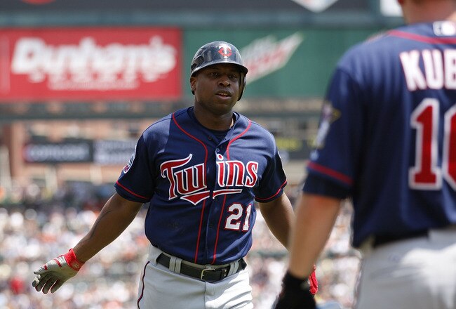 DETROIT - JULY 11: Delmon Young #21 of the Minnesota Twins scores on a double off the bat of Michael Cuddyer to deep left center field in the fifth inning during the game against the Detroit Tigers on July 11, 2010 at Comerica Park in Detroit, Michigan. The Twins defeated the Tigers 6-3.  (Photo by Leon Halip/Getty Images)