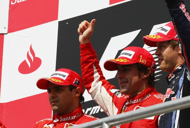 HOCKENHEIM, GERMANY - JULY 25:  Race winner Fernando Alonso (C) of Spain and Ferrari celebrates on the podium with second placed Felipe Massa (L) of Brazil and Ferrari and third placed Sebastian Vettel (R) of Germany and Red Bull Racing following the German Grand Prix at Hockenheimring on July 25, 2010 in Hockenheim, Germany.  (Photo by Andrew Hone/Getty Images)