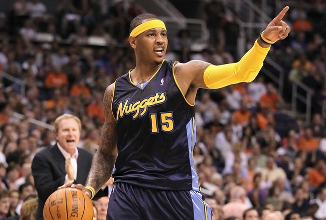 PHOENIX - APRIL 13:  Carmelo Anthony #15 of the Denver Nuggets handles the ball during the NBA game against the Phoenix Suns at US Airways Center on April 13, 2010 in Phoenix, Arizona. The Suns defeated the Nuggets 123-101.  NOTE TO USER: User expressly acknowledges and agrees that, by downloading and or using this photograph, User is consenting to the terms and conditions of the Getty Images License Agreement.  (Photo by Christian Petersen/Getty Images)