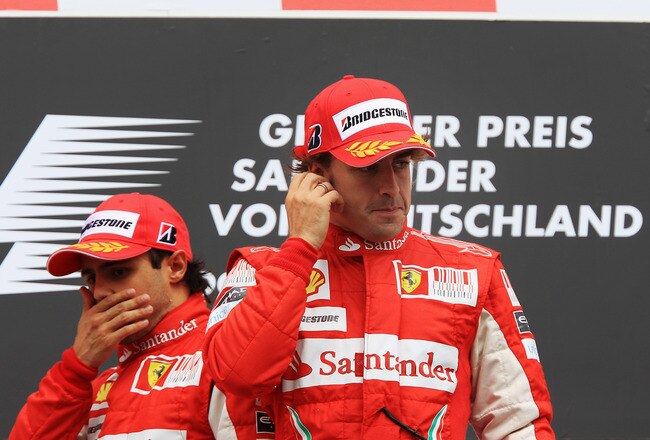 HOCKENHEIM, GERMANY - JULY 25:  Race winner Fernando Alonso (R) of Spain and Ferrari celebrates on the podium with second placed Felipe Massa (L) of Brazil and Ferrari following the German Grand Prix at Hockenheimring on July 25, 2010 in Hockenheim, Germany.  (Photo by Mark Thompson/Getty Images)