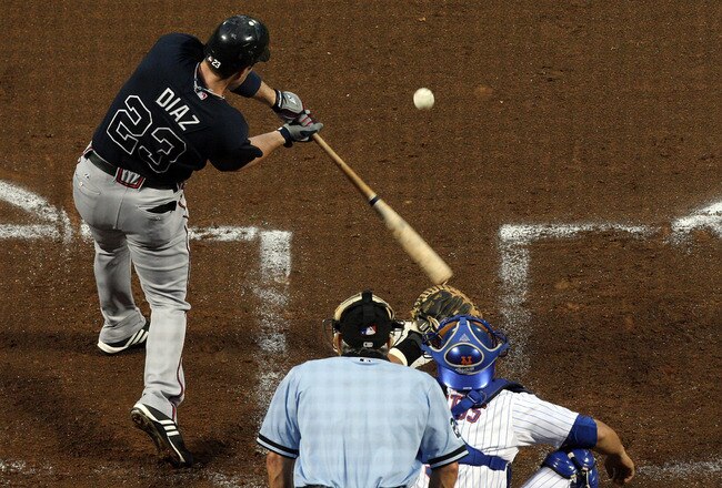 NEW YORK - AUGUST 19:  Matt Diaz #23 of the Atlanta Braves connects for a second inning two run single against the New York Mets on August 19, 2009 at Citi Field in the Flushing neighborhood of the Queens borough of New York City.  (Photo by Jim McIsaac/Getty Images)