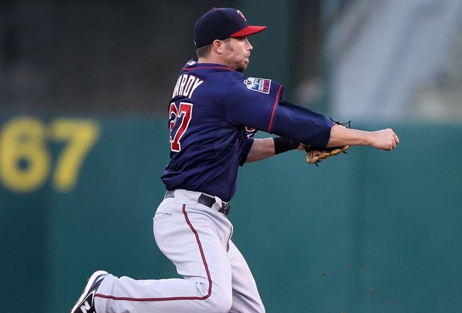 OAKLAND, CA - JUNE 04:  J.J. Hardy #27 of the Minnesota Twins leaps over Kurt Suzuki #8 of the Oakland Athletics on a double play hit by Jack Cust in the fourth inning during an MLB game at the Oakland-Alameda County Coliseum on June 4, 2010 in Oakland, California.  (Photo by Jed Jacobsohn/Getty Images)