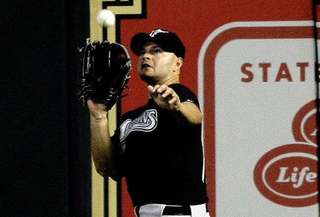 HOUSTON - APRIL 20:  Right fielder Cody Ross #12 of the Florida Marlins makes a catch on a fly ball of the bat of J.R. Towles of the Houston Astros in the fourth inning at Minute Maid Park on April 20, 2010 in Houston, Texas.  (Photo by Bob Levey/Getty Images)