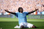 MANCHESTER, ENGLAND - SEPTEMBER 12:  Emmanuel Adebayor of Manchester City celebrates in front of the Arsenal fans after scoring during the Barclays Premier League match between Manchester City and Arsenal at the City of Manchester Stadium on September 12, 2009 in Manchester, England.  (Photo by Shaun Botterill/Getty Images)