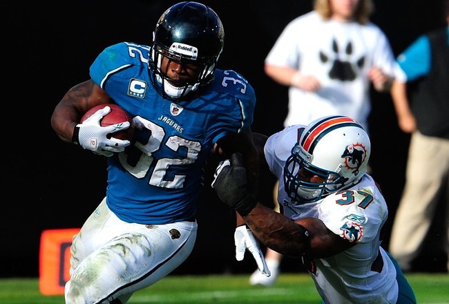 JACKSONVILLE, FL - DECEMBER 13:  Yeremiah Bell #37 of the Miami Dolphins attempts to tackle Maurice Jones-Drew #32 of the Jacksonville Jaguars during the game at Jacksonville Municipal Stadium on December 13, 2009 in Jacksonville, Florida.  (Photo by Sam Greenwood/Getty Images)