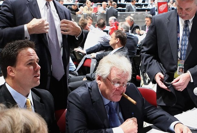 MONTREAL, QC - JUNE 27:  General Manager and President Glen Sather of the New York Rangers (C) works at the draft table during the 2009 NHL Entry Draft at the Bell Centre on June 27, 2009 in Montreal, Quebec, Canada. (Photo by Bruce Bennett/Getty Images)