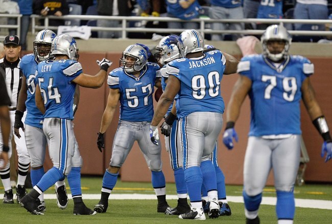 DETROIT , MI - NOVEMBER 26: Jordon Dizon #57 of the Detroit Lions celebrates with teammates during the game against the Green Bay Packers on November 26, 2009 at Ford Field in Detroit, Michigan. Green Bay won the game 34-12. (Photo by Gregory Shamus/Getty Images)