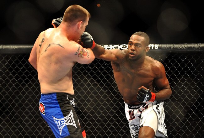 LAS VEGAS - JULY 11:  (R-L) Jon Jones connects with a right punch on Jake O'Brein during their light heavyweight bout during UFC 100 on July 11, 2009 in Las Vegas, Nevada. Jones defeated O'Brein by second round tapout.  (Photo by Jon Kopaloff/Getty Images)