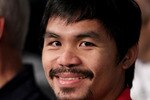 NEW YORK - JUNE 05:  Professional boxer Manny Pacquiao watches the bout between Yuri Foreman and Miguel Cotto of Puerto Rico in the WBA world super welterweight title fight on June 5, 2010 at Yankee Stadium in the Bronx borough of New York City. Cotto wins by TKO in the ninth round. (Photo by Al Bello/Getty Images)