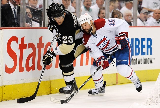 PITTSBURGH - APRIL 30:  Alexei Ponikarovsky #23 of the Pittsburgh Penguins controls the puck as Glen Metropolit #15 of the Montreal Canadiens defends in Game One of the Eastern Conference Semifinals during the 2010 NHL Stanley Cup Playoffs on April 30, 2010 at Mellon Arena in Pittsburgh, Pennsylvania.  (Photo by Jamie Sabau/Getty Images)