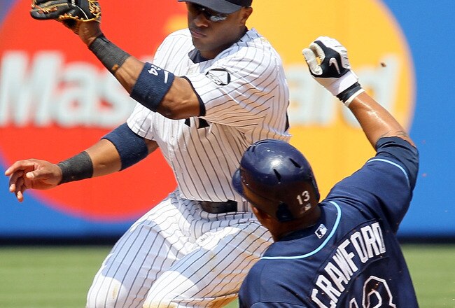NEW YORK - JULY 18:  Robinson Cano #24 of the New York Yankees is late with the tag as Carl Crawford #13 of the Tampa Bay Rays steals second base on July 18, 2010 at Yankee Stadium in the Bronx borough of New York City.  (Photo by Jim McIsaac/Getty Images)