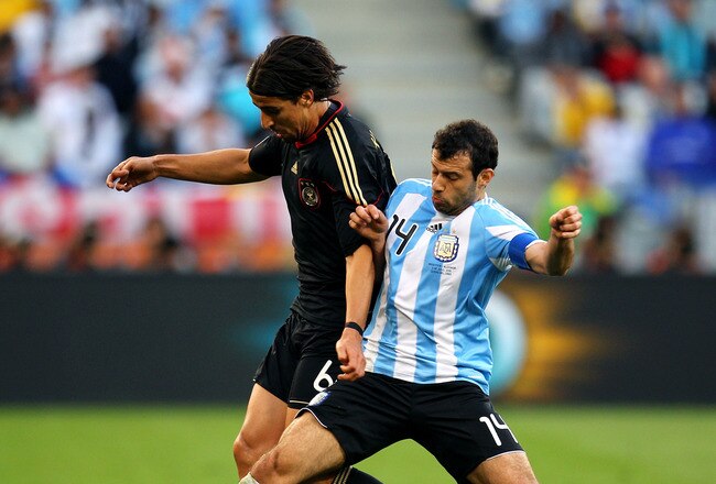 CAPE TOWN, SOUTH AFRICA - JULY 03:  Sami Khedira of Germany and Javier Mascherano of Argentina tussle for the ball during the 2010 FIFA World Cup South Africa Quarter Final match between Argentina and Germany at Green Point Stadium on July 3, 2010 in Cape Town, South Africa.  (Photo by Cameron Spencer/Getty Images)