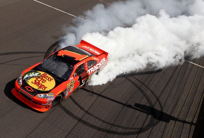 INDIANAPOLIS - JULY 25:  Jamie McMurray, driver of the #1 Bass Pro Shops/Tracker Boats Chevrolet, celebrates with a burn out after winning the NASCAR Sprint Cup Series Brickyard 400 at Indianapolis Motor Speedway on July 25, 2010 in Indianapolis, Indiana.  (Photo by Christian Petersen/Getty Images)