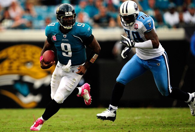 JACKSONVILLE, FL - OCTOBER 04:  David Garrard #9 of the Jacksonville Jaguars is chased by Jacob Ford #78 of the Tennessee Titans during the game at Jacksonville Municipal Stadium on October 4, 2009 in Jacksonville, Florida.  (Photo by Sam Greenwood/Getty Images)