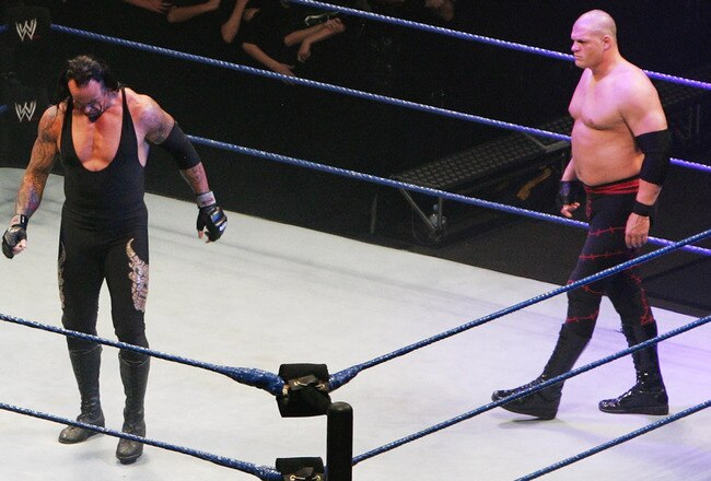 SYDNEY, AUSTRALIA - JUNE 15:  The Undertaker and ECW Champion Kane stand in the ring as the look down to Bam Neely, Chavo Guerrero, and The Great Khali during WWE Smackdown at Acer Arena on June 15, 2008 in Sydney, Australia.  (Photo by Gaye Gerard/Getty Images)