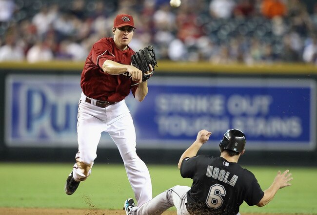 PHOENIX - JULY 11:  Infielder Stephen Drew #6 of the Arizona Diamondbacks throws over the sliding Dan Uggla #6 of the Florida Marlins to complete a double play during the fourth inning of the Major League Baseball game at Chase Field on July 11, 2010 in Phoenix, Arizona.  (Photo by Christian Petersen/Getty Images)