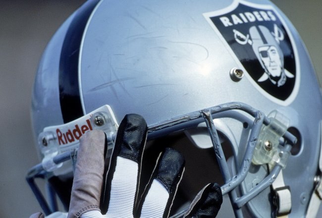 24 Dec 2000:  A player of the Oakland Raiders holds up a helmet during the game against the Carolina Panthers at the Network Associates Coliseum in Oakland, California.  The Raiders defeated the Panthers 52-9.Mandatory Credit: Tom Hauck  /Allsport