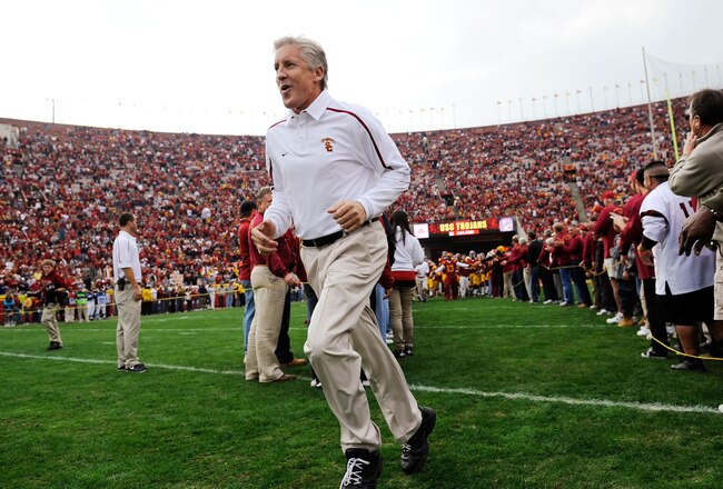 LOS ANGELES, CA - DECEMBER 05:  Coach Pete Carroll of the USC Trojans leads his team on to the field prior to the start of the NCAA college football game against Arizona Wildcats at the Los Angeles Coliseum on December 5, 2009 in Los Angeles, California.  (Photo by Kevork Djansezian/Getty Images)