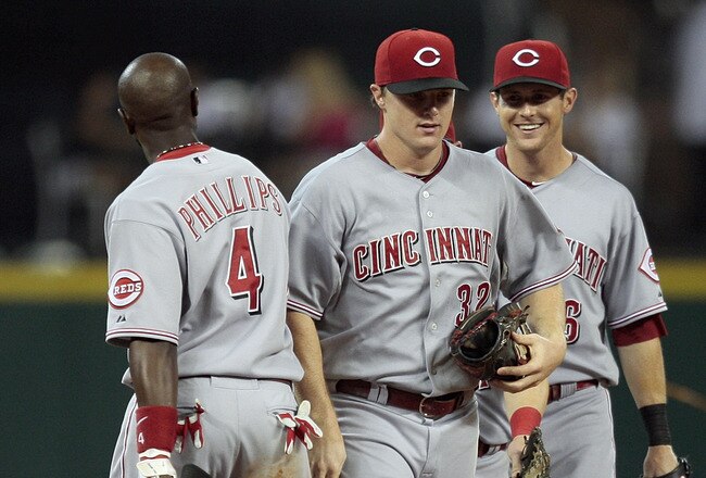 HOUSTON - JULY 24:  Brandon Phillips #4 celebrates with Jay Bruce #32 and Drew Stubbs #6 of the Cincinnati Reds after defeating the Houston Astros at Minute Maid Park on July 24, 2010 in Houston, Texas.  (Photo by Bob Levey/Getty Images)