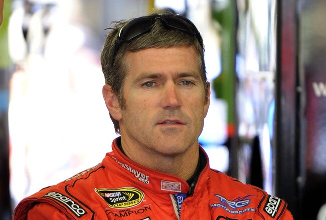 LOUDON, NH - JUNE 26:  Bobby Labonte, driver of the #7 SpeedFactory.TV Toyota, stands in the garage during practice for the NASCAR Sprint Cup Series LENOX Industrial Tools 301 at New Hampshire Motor Speedway on June 26, 2010 in Loudon, New Hampshire.  (Photo by Drew Hallowell/Getty Images for NASCAR)