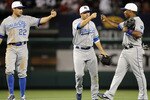 ANAHEIM, CA - JULY 02:  Jose Guillen #6, David DeJesus #9 and Scott Podsednik #22 of the Kansas City Royals celebrate a 2-1 victory over the Los Angeles Angels during the 10th inning at Angel Stadium on July 2, 2010 in Anaheim, California.  (Photo by Harry How/Getty Images)