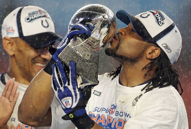 MIAMI GARDENS, FL - FEBRUARY 04:  Bob Sanders #21 of  the Indianapolis Colts kisses the Vince Lombardi Trophy, next to head coach Tony Dungy, after the Colts 29-17 win against the Chicago Bears in Super Bowl XLI on February 4, 2007 at Dolphin Stadium in Miami Gardens, Florida.  (Photo by Jonathan Daniel/Getty Images)