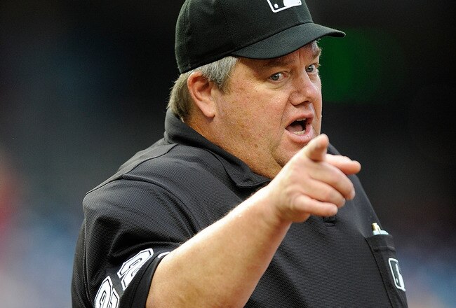 WASHINGTON - JUNE 05:  Home plate umpire Joe West motions to the Nationals bench during the game between the Cincinnati Reds and the Washington Nationals at Nationals Park on June 5, 2010 in Washington, DC.  (Photo by Greg Fiume/Getty Images)