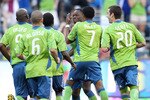 SEATTLE - JULY 25:  Steve Zakuani #11(center facing camera) of the Seattle Sounders FC celebrates with teammates after scoring against the Colorado Rapids on July 25, 2010 at Qwest Field in Seattle, Washington. (Photo by Otto Greule Jr/Getty Images)