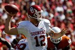 DALLAS - OCTOBER 17:  Quarterback Landry Jones #12 of the Oklahoma Sooners drops back to pass against the Texas Longhorns at Cotton Bowl on October 17, 2009 in Dallas, Texas.  (Photo by Ronald Martinez/Getty Images)