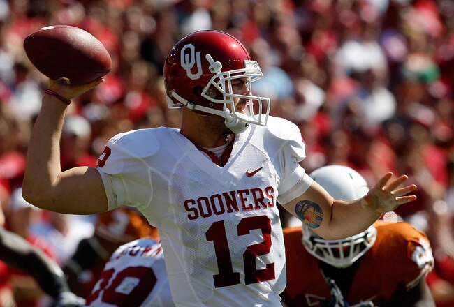 DALLAS - OCTOBER 17:  Quarterback Landry Jones #12 of the Oklahoma Sooners drops back to pass against the Texas Longhorns at Cotton Bowl on October 17, 2009 in Dallas, Texas.  (Photo by Ronald Martinez/Getty Images)