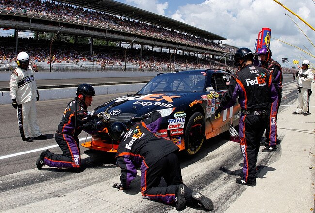 INDIANAPOLIS - JULY 25:  Denny Hamlin, driver of the #11 FedEx Office Toyota, pits during the NASCAR Sprint Cup Series Brickyard 400 at Indianapolis Motor Speedway on July 25, 2010 in Indianapolis, Indiana.  (Photo by Jason Smith/Getty Images)