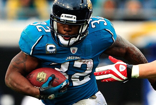 JACKSONVILLE, FL - DECEMBER 06:  Brian Cushing #56 of the Houston Texans attempts to tackle Maurice Jones-Drew #32 of the Jacksonville Jaguars during the game at Jacksonville Municipal Stadium on December 6, 2009 in Jacksonville, Florida.  (Photo by Sam Greenwood/Getty Images)