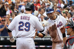 NEW YORK - JULY 29:  Ike Davis #29 of the New York Mets is congratulated by teammate Carlos Beltran #15 after his third inning three run home run as Yadier Molina #4 of the St. Louis Cardinals looks on, on July 29, 2010 at Citi Field in the Flushing neighborhood of the Queens borough of New York City.  (Photo by Jim McIsaac/Getty Images)