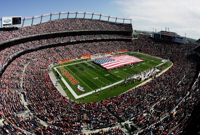 DENVER - SEPTEMBER 17:  A giant American Flag is unfurled on the field during the National Anthem before the Kansas City Chiefs game against the Denver Broncos at INVESCO Field at Mile High on September 17, 2006 in Denver, Colorado. The Broncos defeated the Chiefs 9-6 in overtime.  (Photo by Doug Pensinger/Getty Images)