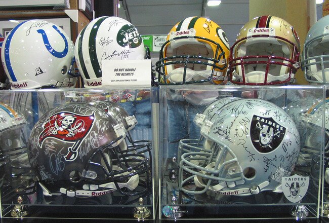 SAN DIEGO - JANUARY 23:  Autographed NFL helmets are on display for sale in the card and collectables area at the NFL Experience on January 23, 2003 in San Diego, California, California.  The Oakland Raiders will play the Tampa Bay Buccaneers in Super Bowl XXXVII on Sunday January 26.   (Photo by Stephen Dunn/Getty Images)